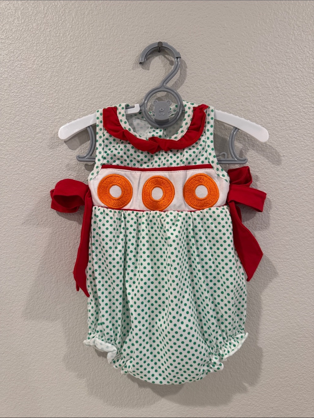 Green Polka Dot Baby Bubble Romper with Red Trim and Orange Accents